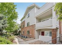 Attractive condo building with brick and siding exterior, balconies, and landscaping at 10129 W 55Th Dr # 3, Arvada, CO 80002