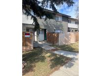 A cozy townhome featuring a fenced front yard with a 'For Rent' sign and a well-maintained lawn at 8023 Wolff St # F, Westminster, CO 80031