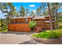 Inviting exterior view of a two story home, with a three car garage and well maintained yard at 6154 Belmont Way, Parker, CO 80134