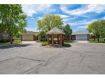 View of a charming gazebo surrounded by well-kept homes and lush trees in the neighborhood at 9214 Winona Ct, Westminster, CO 80031