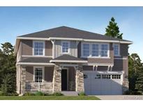 Charming two-story home featuring a stone-accented porch and attached garage at 767 Raindance St, Erie, CO 80516