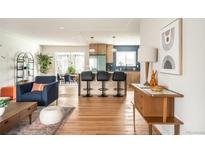 Open floor plan showing the living room flowing into the kitchen and dining areas at 815 S Jersey St, Denver, CO 80224