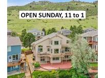 Attractive, multi-level home with a large deck and a picturesque mountain view beyond at 165 Washington St, Golden, CO 80403