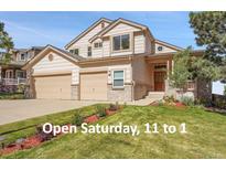 Two-story home with a two-car garage, lush lawn, and an open house on Saturday from 11 to 1 at 165 Washington St, Golden, CO 80403