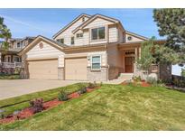 Charming two-story home with a three car garage, manicured lawn, and beautiful landscaping at 165 Washington St, Golden, CO 80403