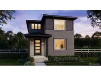 Charming two-story home featuring a modern design, dark siding, brick accents, and a well-manicured front lawn at 7251 Goldbloom Ln, Littleton, CO 80125