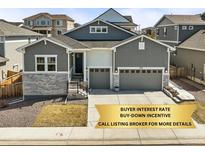 Charming two-story home featuring a gray exterior, stone accents, and a convenient two-car garage at 2766 Keepsake Way, Castle Rock, CO 80109