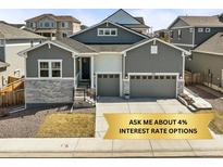 Charming gray two-story home with a two-car garage and stone accents, offering curb appeal at 2766 Keepsake Way, Castle Rock, CO 80109