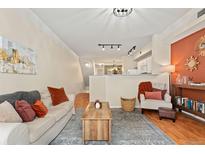 Comfortable living area with ample seating, a decorative rug, and a view into the kitchen area at 2169 Eagle Ave # 2169, Superior, CO 80027