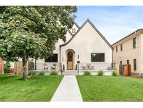 Charming home featuring a well-manicured lawn, a walkway, and a decorative fence with outdoor seating at 659 Albion St, Denver, CO 80220