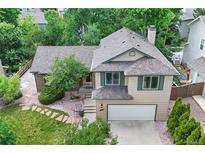 Charming two-story home with neutral siding, a two-car garage, and mature landscaping at 8725 Meadowlark Cir, Highlands Ranch, CO 80126