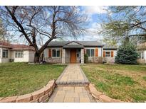 Charming single-story home with stone accents, shutters, landscaping, and welcoming walkway at 1891 S Madison St, Denver, CO 80210