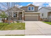 Charming two-story home featuring a covered porch, well-maintained lawn, and inviting curb appeal at 11704 Hale Ct, Parker, CO 80138