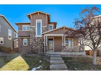 Charming two-story home with stone accents and inviting front porch in a well-maintained neighborhood at 17086 E 106Th Ave, Commerce City, CO 80022