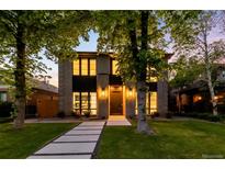 Charming two-story home with modern brickwork, large windows, and professional landscaping, offering great curb appeal at 1241 S Garfield St, Denver, CO 80210