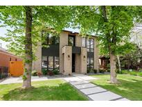 Striking modern home featuring a tan brick facade, expansive windows, and a welcoming walkway at 1241 S Garfield St, Denver, CO 80210