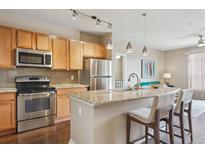 Modern kitchen featuring stainless steel appliances, granite counters, and bar seating at 10184 Park Meadows Dr # 1303, Lone Tree, CO 80124