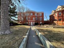 Charming brick building with a landscaped walkway leading to the main entrance at 3233 Vallejo St # 1C, Denver, CO 80211