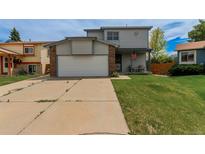 Charming two-story home with a spacious two-car garage and well-maintained lawn at 6119 Zenobia Ct, Arvada, CO 80003