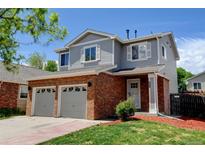 Charming two-story home featuring a brick facade, two-car garage, and well-maintained landscaping in a suburban neighborhood at 3769 Dahlia St, Denver, CO 80207