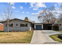 Charming single Gathering home featuring a brick exterior, attached garage and a well-manicured front yard at 794 S Ivy St, Denver, CO 80224