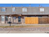 Two-story brick townhome featuring a fenced yard and well-maintained landscaping at 1379 S Idalia St # C, Aurora, CO 80017