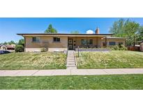 Charming brick home with a covered front porch and well-maintained front yard at 2501 E Arkansas Ave, Denver, CO 80210