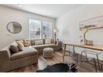 Cozy living room with large windows, comfortable seating, and stylish decorative accents at 2036 S Vance Way, Lakewood, CO 80227