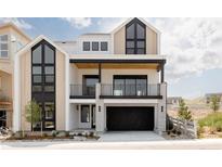 Modern two-story home featuring a black garage door, sleek balcony, and stylish architectural details at 11468 Alla Breve Cir, Lone Tree, CO 80134