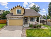 Charming two-story home with a welcoming front porch and well-maintained lawn and attached two car garage at 10530 Mount Columbia Pl, Parker, CO 80138