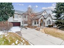 Stately home featuring a concrete driveway and a combination of stucco and stone exterior accents at 215 Locust Ln, Denver, CO 80220