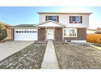 Charming two-story home with brick accents and a well-maintained front yard at 8062 Kalamath St, Denver, CO 80221