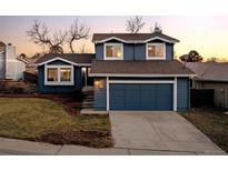 Beautiful two-story home with a two-car garage, mature trees, and an inviting entrance at 322 Mountain Cloud Cir, Highlands Ranch, CO 80126