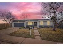 Charming single-story home featuring a well-manicured front yard and an attached garage, perfect for suburban living at 15756 E Temple Pl, Aurora, CO 80015