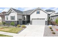 Charming single-Gathering home showcasing a stone accents, well-manicured lawn, and a two-car garage at 20272 Terrace View Dr, Parker, CO 80134
