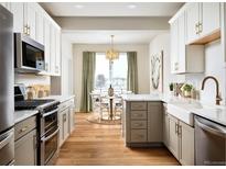 Bright, modern kitchen with stainless steel appliances and adjacent dining area bathed in natural light at 888 S Valentia St # 102, Denver, CO 80247