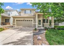 Charming two-story home featuring a two-car garage and a beautifully landscaped front yard at 19463 E Hollow Creek Dr, Parker, CO 80134
