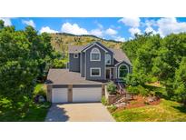 Beautiful two-story home featuring a three-car garage and manicured landscaping at 469 Tripp Dr, Golden, CO 80401