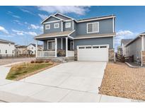Charming two-story home featuring a covered porch, attached two car garage and mature landscaping at 2186 Prairie Smoke Dr, Monument, CO 80132
