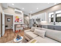Bright, open-concept living space with modern kitchen, stainless appliances, and comfortable seating area at 3219 W 19Th Ave # 3, Denver, CO 80204
