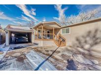 Inviting home featuring a covered porch, convenient carport, and well-maintained yard at 6500 E 88Th Ave # 258, Henderson, CO 80640