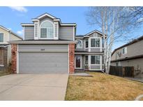 Charming two-story home with a two-car garage and brick accents at 5215 S Jebel Way, Centennial, CO 80015