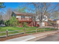 Charming home featuring a spacious deck and well-maintained front yard at 7065 S Willow St, Centennial, CO 80112