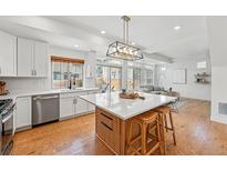 Beautiful kitchen with stainless appliances, island with bar seating and lots of natural light at 10123 Zeno St, Commerce City, CO 80022