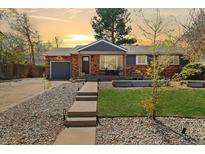 Charming brick home with a cozy front porch and well-maintained front yard landscaping at 882 E Briarwood Cir, Centennial, CO 80122