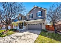 Charming two-story home featuring a welcoming front porch and a two-car garage with beautiful lawn at 7430 E Bayaud Ave, Denver, CO 80230