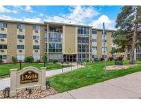Well-maintained condo building with manicured lawn and visible signage for easy identification at 13606 E Bates Ave # 304, Aurora, CO 80014