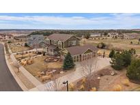 Beautiful two-story home with a three car garage, landscaped yard and basketball court on a manicured lot at 7635 Weaver Cir, Castle Rock, CO 80104