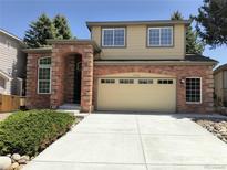 Charming two-story home featuring a brick facade, two-car garage, and well-maintained landscaping at 10538 Tiger, Lone Tree, CO 80124