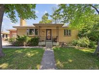 Charming brick home featuring a covered porch and well-maintained front yard at 6050 Marshall Ct, Arvada, CO 80003